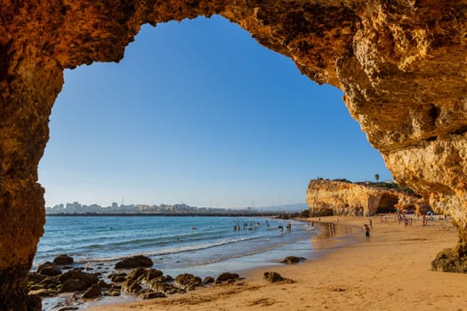 Ferragudo, Portugal - 25 August 2025: Beautiful seascape with beach, cave and ocean. Pintadinho beach. Ferragudo, Lagoa, Algarve, Portugal