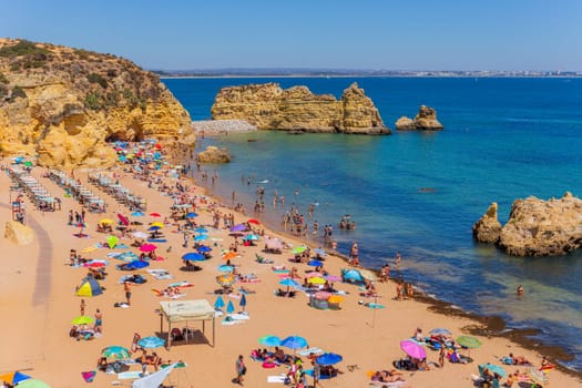 Lagos, Portugal - 25 August 2022: People at Dona Ana beach at Algarve coast in Portugal