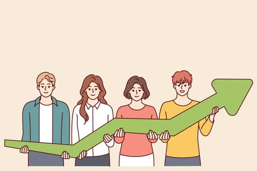 Team of men and women together hold green arrow pointing up, symbolizing development and success business. Concept of growth in financial performance due to teamwork of company employees