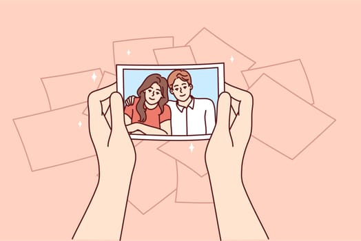 Photo with hugging couple man and woman in hands of girl experiencing nostalgia and remembering past. Memorable photo with friends during family holiday or walk together for concept remembering past
