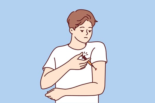 Man with diabetes makes injection in arm to lower blood sugar and avoid insulin shock. Guy is experiencing problems and need for regular injections after suffering from diabetes or infectious flu