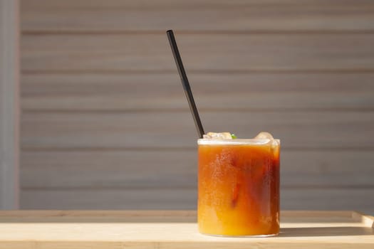 Iced coffee with orange in coffee shop, stock photo