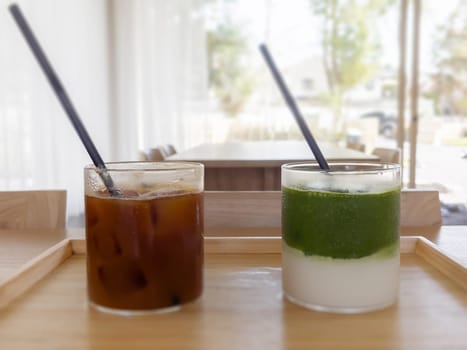 Iced americano with orange and iced matcha green tea in coffee shop, stock photo