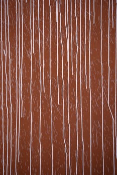 Detail of red wall damaged by vandalism and crime