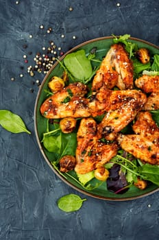 Baked chicken wings with vegetables. Poultry meat