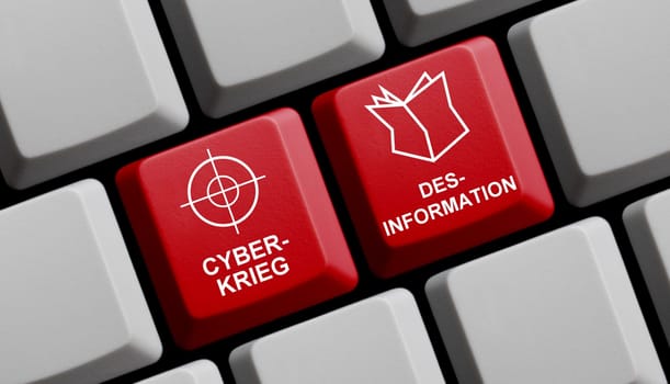 Cyber War and Disinformation in german language on red computer keyboard 3D illustration