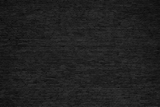 Black brick wall background with weathered stones