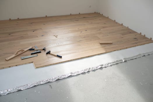 parquet floor laying in a new room, loft, new house
