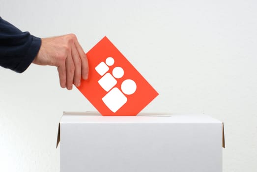 Ballot box and hand inserting envelope with people icons