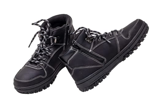 Winter boots. Close-up of a pair elegant black leather winter boots with laces and rivets isolated on white. Clipping path. Macro. Autumn shoe fashion for child boy.