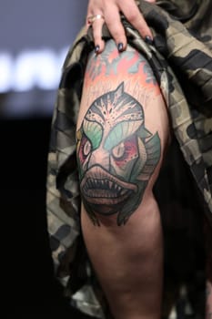 Krakow, Poland - June 11, 2022: Unidentified participant during the contest for the best tattoo at the 15th Tattoofest Convention in Cracow. One of the most prestigious tattoo festivals.