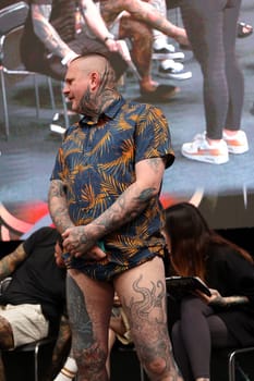 Krakow, Poland - June 12, 2022: Unidentified participant during the contest for the best tattoo at the 15th Tattoofest Convention in Cracow. One of the most prestigious tattoo festivals.