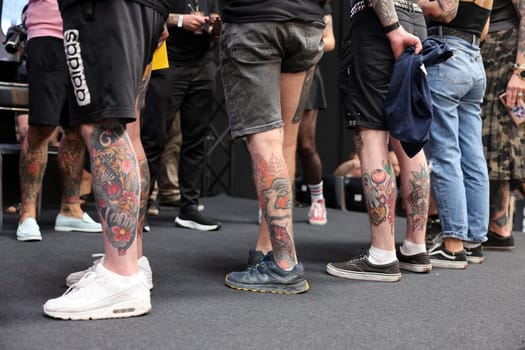 Krakow, Poland - June 11, 2022: Unidentified participant during the contest for the best tattoo at the 15th Tattoofest Convention in Cracow. One of the most prestigious tattoo festivals.