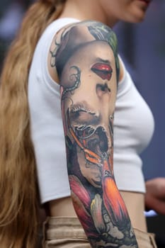 Krakow, Poland - June 12, 2022: Unidentified participant during the contest for the best tattoo at the 15th Tattoofest Convention in Cracow. One of the most prestigious tattoo festivals.