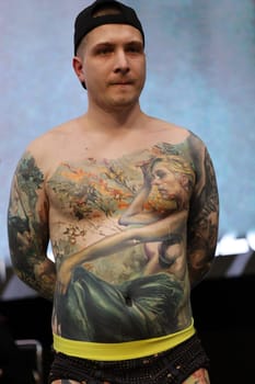Krakow, Poland - June 12, 2022: Unidentified participant during the contest for the best tattoo at the 15th Tattoofest Convention in Cracow. One of the most prestigious tattoo festivals.