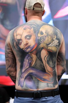 Krakow, Poland - June 12, 2022: Unidentified participant during the contest for the best tattoo at the 15th Tattoofest Convention in Cracow. One of the most prestigious tattoo festivals.