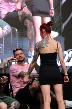 Krakow, Poland - June 11, 2022: Unidentified participant during the contest for the best tattoo at the 15th Tattoofest Convention in Cracow. One of the most prestigious tattoo festivals.