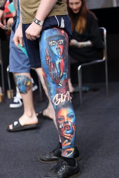 Krakow, Poland - June 12, 2022: Unidentified participant during the contest for the best tattoo at the 15th Tattoofest Convention in Cracow. One of the most prestigious tattoo festivals.