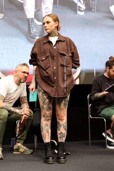 Krakow, Poland - June 11, 2022: Unidentified participant during the contest for the best tattoo at the 15th Tattoofest Convention in Cracow. One of the most prestigious tattoo festivals.