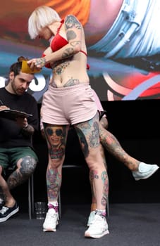 Krakow, Poland - June 11, 2022: Unidentified participant during the contest for the best tattoo at the 15th Tattoofest Convention in Cracow. One of the most prestigious tattoo festivals.