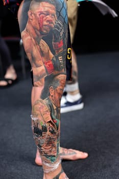 Krakow, Poland - June 12, 2022: Unidentified participant during the contest for the best tattoo at the 15th Tattoofest Convention in Cracow. One of the most prestigious tattoo festivals.
