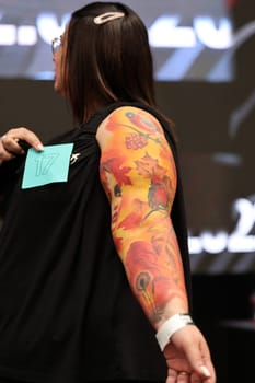 Krakow, Poland - June 12, 2022: Unidentified participant during the contest for the best tattoo at the 15th Tattoofest Convention in Cracow. One of the most prestigious tattoo festivals.