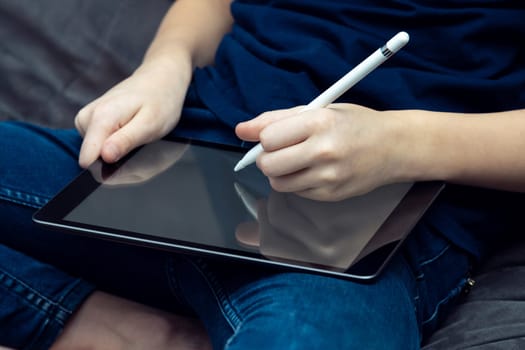 Digital tablet computer with blank screen in male hands closeup. Business man work on multitasking handheld gadget with stylus. Sensory pen drawing and writing, touchscreen, electronics.