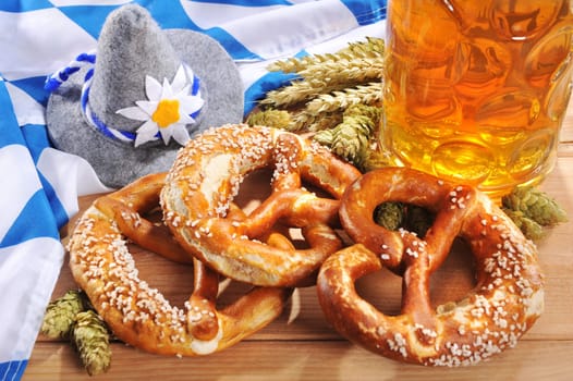original Bavarian Laugenbrezen with Oktoberfest beer mug and Bavarian flag