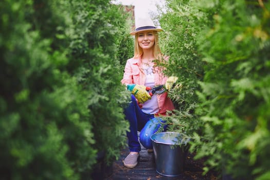 Young woman looking at camera while working in the garden