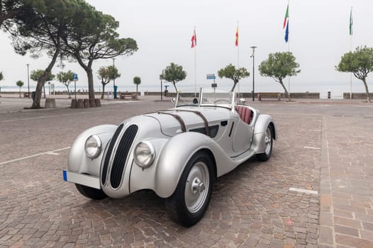 SIRMIONE, Province of Brescia,  ITALY - MAY 08 unidentified crew on an old car BMW 328 coupe  1938 in italian historical rally Mille Miglia 2014, on May 08, 2014 in  Lake Garda town of Sirmione, Italy