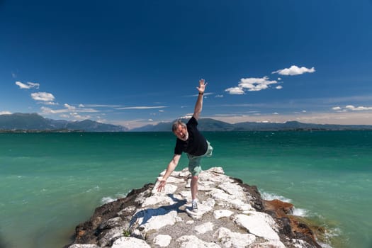 Lake Garda Italy. happy man against the backdrop of emerald water