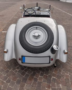 SIRMIONE, Province of Brescia,  ITALY - MAY 08 unidentified crew on an old car BMW 328  1938 back view in italian historical rally Mille Miglia 2014, on May 08, 2014 in  Lake Garda town of Sirmione, Italy