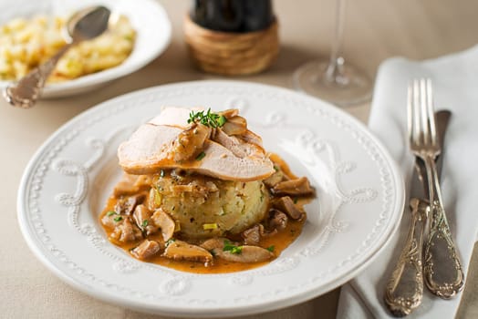 Chicken breast in mushroom sauce with potatoes close up