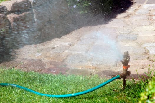 A lawn sprinkler or sprinkler system on a lawn in a garden.