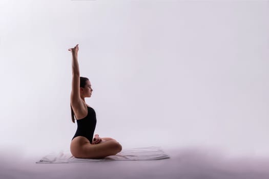 Image of a young plump female doing acrobatic stunt, studio shot