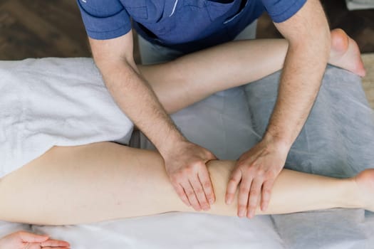 Anti-cellulite foot massage for fat woman. Concept of personal care, weight loss, diet. Close-up.