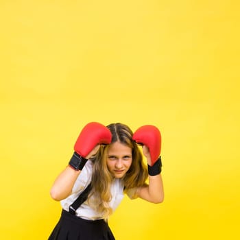 Little girl wearing red boxing gloves, studio shot, sport conception