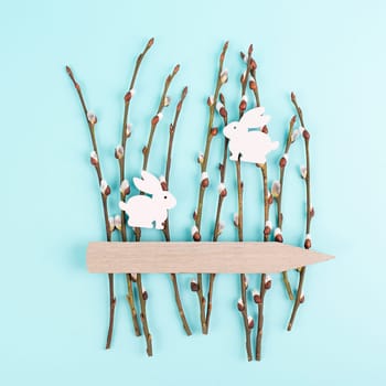 Willow branches with bunny and a tag, easter holiday greeting card, spring season background