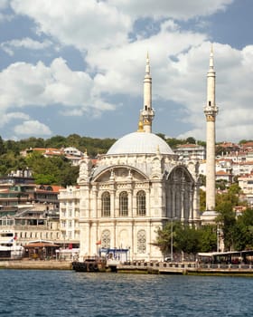 View from Bosphorus Strait overlooking Ortakoy Mosque, or Ortakoy Camii, aka Buyuk Mecidiye Camii, suited at the waterside of the Ortakoy pier square, Istanbul, Turkey