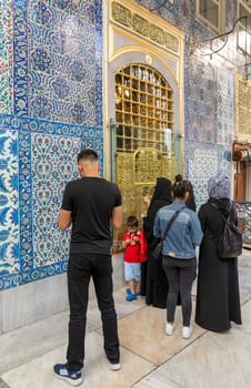 Istanbul, Turkey - September 1 2022: People praying in front of the tomb of Abu Ayyub al-Ansari at Eyup Sultan Mosque