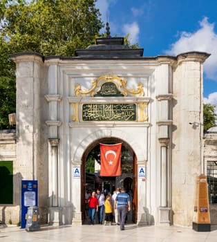 Istanbul, Turkey - September 1, 2023: Entrance of Eyup Sultan Mosque with pedestrians, situated in the Eyup district of Istanbul, Turkey outside the city walls near the Golden Horn