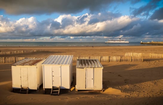 Beautiful landscape of the coast and harbor with cabins and the departure of a ferry in Calais, north of France
