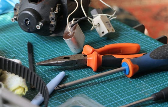 pliers, screwdriver tool on desktop in repair shop
