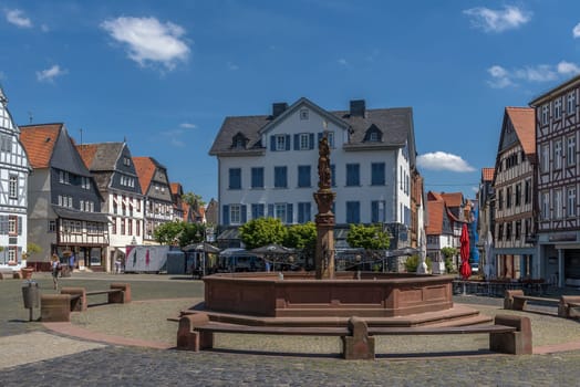 View of the historic market square with a fountain in Butzbach, Hesse, Germany.