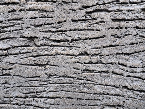 Texture of concrete and plaster on the wall. Drips on the wall. Wavy lines in the plaster. Texture of concrete and plaster. Gray color.