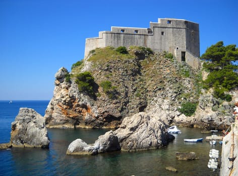 Fort of St. Lawrence in Dubrovnik, Croatia. Attractions of the Adriatic coast. Tourist routes. Fortress on a high rocky seashore. Blue sea and sky. Lovrijenac.