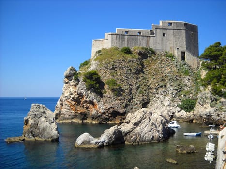 Fort of St. Lawrence in Dubrovnik, Croatia. Attractions of the Adriatic coast. Tourist routes. Fortress on a high rocky seashore. Blue sea and sky. Lovrijenac.