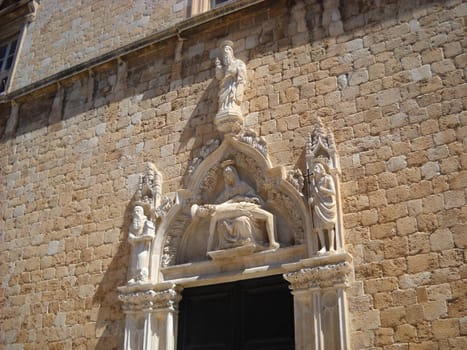 Dubrovnik, Dalmatia, Croatia - August 5, 2010 Landmarks of Croatia. Old town of Dubrovnik. The wall of a building or church. Sculptures made of stucco or plaster. Biblical and religious figurines.