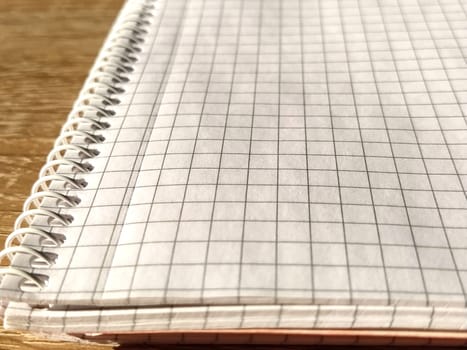Checkered notebook with spiral. An open notepad for notes. Soft focus. Copy space. Blank blank page for your text.