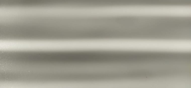 blurred striped gray background. Play of light and shadow. Light beams. Gray and silver shades with white dots and shining stars